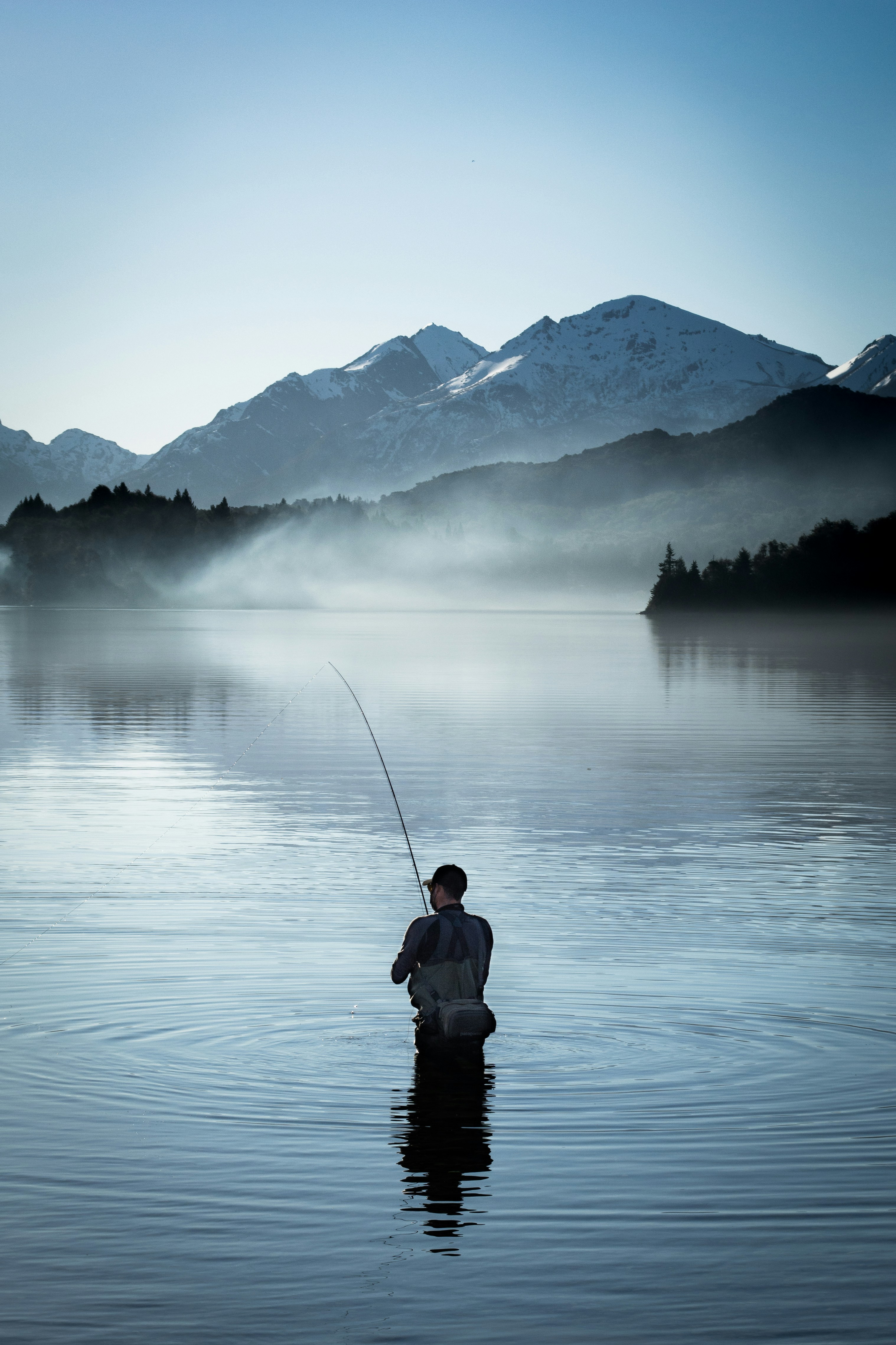 Fly fisher in a mountain lake